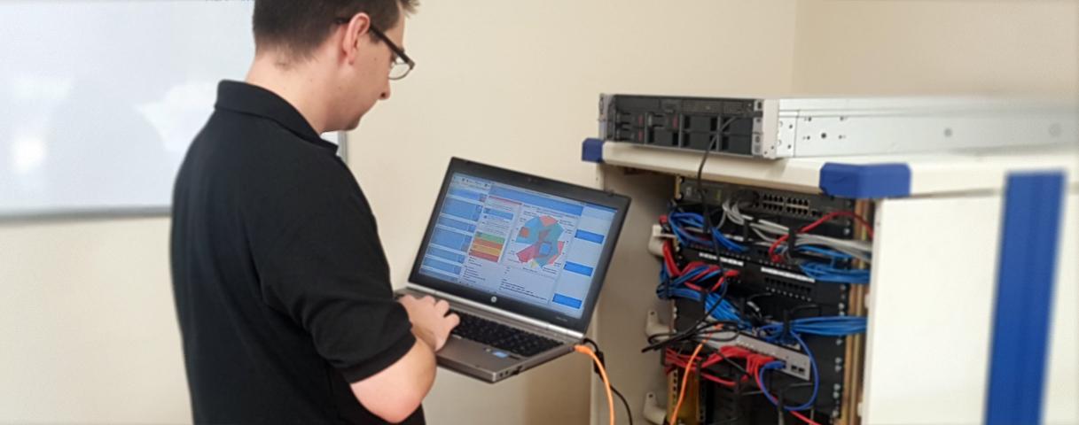 Technician carrying out routine maintenance on business equipment